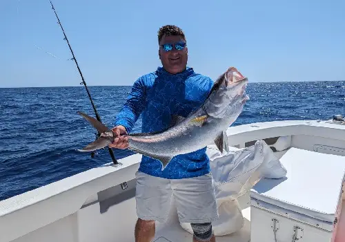 Happy fisherman showing off her catch after Deep-Sea Fishing in St. Petersburg FL